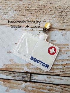 an id badge with the name doctor on it is attached to a wooden surface,