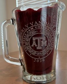 a glass mug with a maroon colored liquid in it