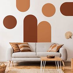 a living room filled with furniture and lots of circles on the wall