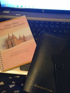 a book sitting on top of a laptop computer next to a mouse and keyboard pad