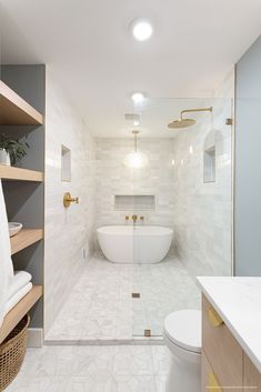 a bathroom with a tub, toilet and sink in it's center wall is shown