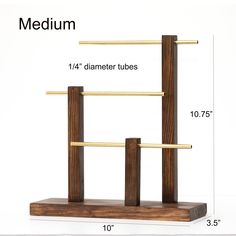 a wooden stand with three metal tubes on it and measurements for each tube in the same size