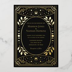 a black and gold wedding card with an ornate frame on the front, surrounded by stars