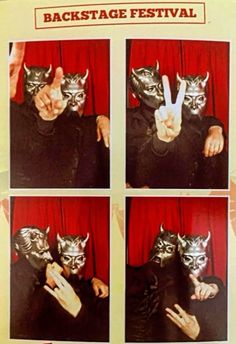 a person in black shirt and silver mask making peace sign with their hands while holding up two fingers