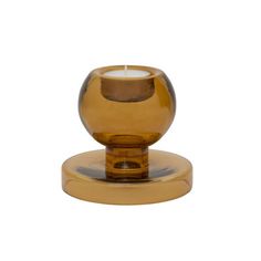 a glass vase sitting on top of a wooden stand in front of a white background