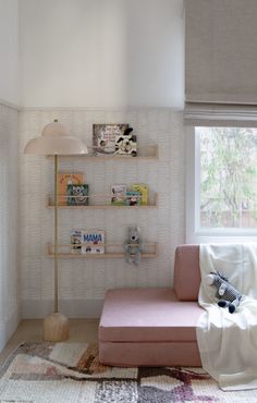 a living room filled with furniture and a window covered in a white blanket on top of a rug