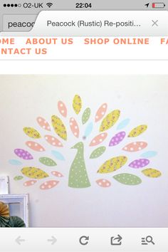 a white wall with a colorful tree painted on it and the words home about us shop online fast