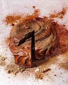 a chocolate cake sitting on top of a table covered in dirt