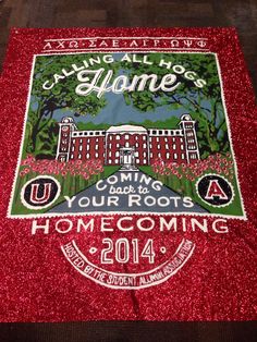 a red and green banner with the words coming home on it's front side