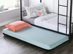 a bunk bed with a mattress on the bottom and pillows on the bottom, in a room with hardwood floors