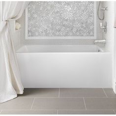 a white bath tub sitting next to a shower curtain