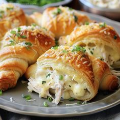 several croissants filled with meat and cheese on a plate