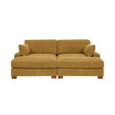 a brown couch sitting on top of a white floor next to a wooden leg chair