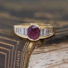 Talk about a gorgeous pop of color! The ruby has a deep and rich red color, contrasting beautifully against the white baguette diamonds. As sexy and sensous as only the French can make! A great choise for those looking for a non-diamond engagement ring. 18kt Yellow gold, size 6 & fully resizable.Ruby is estimated to be SI2/I1 type II clarity.Diamonds are estimated to be G/H colors & VVS/VS clarities.GIA standards.Please see qualitative report for more information. Red Ruby Ring With Vvs Clarity And Baguette Cut, Red Baguette Cut Lab-created Ruby Ring, Luxury Red Baguette Diamond Jewelry, Elegant Ruby Ring With Baguette Cut, Red Baguette Cut Diamond Accent Jewelry, Red Baguette Cut Ruby Ring, Red Ruby Ring With Baguette Cut Center Stone, Red Ruby Ring With Baguette Diamonds, Luxury Red Ruby Ring Baguette Cut