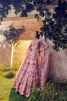 Featuring a salmon pink organza lehenga embellished fully by hand with intricate foliage motifs featuring thread work, sequence, beads and colourful Japanese bugle beads. Paired with a matching blouse and scallop dupattaFrom Aneesh Agarwaal's Ellora collection.DELIVERY TIMEPlease allow 8-12 weeks for your outfit to arrive.FABRIC DETAILSOrganzaProfessional cleaning only. Pink Sharara With Floral Embroidery In Tissue Silk, Pink Tissue Silk Sharara With Floral Embroidery, Floral Embroidered Organza Lehenga For Navratri, Navratri Organza Lehenga With Floral Embroidery, Diwali Organza Gown With Floral Embroidery, Pink Organza Gown With Floral Embroidery, Pink Organza Lehenga With Pallu, Pink Organza Choli With Traditional Drape, Traditional Organza Choli With Floral Embroidery