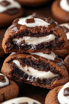 chocolate cookies with white frosting are stacked on top of each other