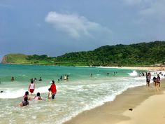 many people are on the beach and in the water at this point, there is no image here to provide a caption for