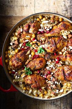 a pot filled with rice and meat on top of a wooden table