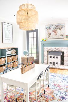 a living room filled with furniture and a fire place under a chandelier over a white table