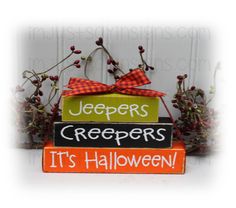 a sign that says jeepers creepers it's halloween on top of two stacked blocks