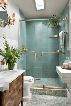 a bathroom with blue tile and gold fixtures