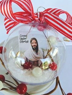 a glass ornament with a man's face in the center and candy canes around it