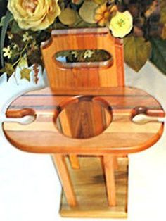 a wooden chair sitting on top of a table next to flowers