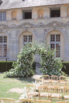 an outdoor wedding venue with chairs set up in front of the entrance to the building