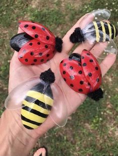 three plastic ladybugs sitting on top of each other in the palm of someone's hand