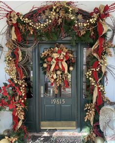 the front door is decorated with wreaths and decorations