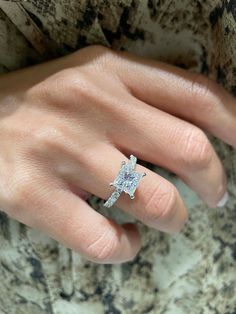 a woman's hand with a diamond ring on it