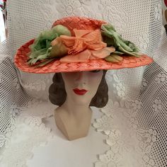 Vintage 1950's 1960's hat. Orange cellophane straw adorned with Orange and Green flowers. The label is *Styled By Abbye'*. Larger size hat. *SCROLL DOWN FOR CONDITION & MEASUREMENTS* CONDITION: No issues noted. MEASURES: Inside circumference~22" Height~4" Front to back~6 1/2" Left to right~7 1/2" *WE APOLOGIZE~BUT WE NO LONGER SHIP TO GERMANY, ITALY OR SPAIN. IF ORDERS COME IN FROM GERMANY, ITALY OR SPAIN, WE WILL HAVE TO CANCEL THEM AND REFUND YOUR MONEY. SORRY FOR THIS INCONVENIENCE* Vintage Sun Hat For Summer Party, Retro Costume Hats And Headpieces For Church, Vintage Summer Sun Hat For Party, Retro Short Brim Hat For Kentucky Derby, Vintage Wide Brim Sun Hat For Wedding, Vintage Costume Hats For Spring Party, Vintage Spring Party Costume Hats And Headpieces, Vintage Brimmed Sun Hat For Wedding, Vintage Costume Hats And Headpieces For Spring Party