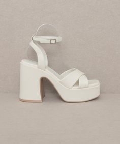 This gorgeous chunky sandal is bringing all the 70's glam. The Norah features a cross strap front and a sweet ankle buckle detail.Heel Height: 4.25"The front platform: 1.5"Types of closures: Slip on/ BuckleClog, Retro, VintageMade In: Imported Hoco Shoes, 70s Shoes, 70s Glam, Fancy Heels, Chunky Platform Sandals, Twinkle Toes, Chunky Sandals, Wrap Heels, Platform Heels Chunky