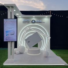 an exhibit stand with white electronic devices on display