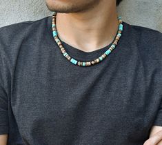 "~Beaded necklace made with turquoise and coconut beads with antique brass spacers. ~19\" long with 2\" extender chain. Your item will arrive in a drawstring pouch - Ready for Gift Giving! *The brown/black beaded necklace shown layered on the model is available here: https://www.etsy.com/ca/listing/1289128938/coconut-wooden-bead-necklace-natural?click_key=e3ae38bd0bb535c5fcf879d86dbde59c49071a70%3A1289128938&click_sum=1c51aa73&ref=shop_home_active_1" Beads Necklace Aesthetic Men, Ceramic Beads Necklace, Boys Necklace, Beaded Boho Necklace, Mens Beaded Necklaces, Wooden Bead Necklaces, Surfer Necklace, Black Bead Necklace, Wooden Necklace