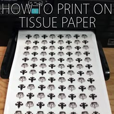 a paper tray with black and white fleur de lis on it, in front of a toaster oven