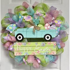 a wreath with a blue truck on it that says happy easter