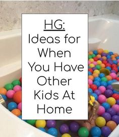 a bathtub filled with lots of colorful balls and the words hg ideas for when you have other kids at home