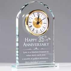 a glass clock with the words happy 35th anniversary on it