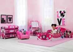 a child's bedroom decorated in pink and minnie mouse theme