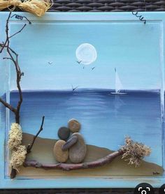 a painting of two rocks sitting on top of a tree branch next to the ocean