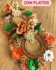 a close up of a piece of fabric with flowers on it and the words coin platter