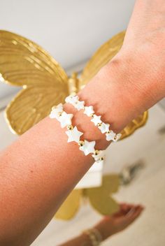 "✤ Bracelets are each sold separately ✤ ⊶ Dainty and beautiful, mother of pearl star charms that are paired with 24k gold filled beads. ⊶ Measurements: Small Star: 8mm - Gold Beads: 3mm Large Star: 11mm - Gold Beads: 5mm ⊶ Model wears bracelet at 6.5 inches ⊶ Gently Handmade and Polished ⊶ Each order comes ready for gifting! ⊶ Orders are sent out the next day Mon-Fri ⊶ Orders cannot be changed once they have been placed due to the high volume and quick turnaround we work hard to maintain. Since Rainbow Jewelry, Wear Necklaces, Dainty Gold Necklace, Shell Bracelet, Boho Bracelet, Star Bracelet, Jewelry Boho, Jewelry Bracelet, Coin Necklace