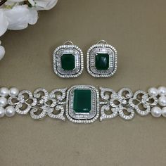 Emerald Choker features stunning green diamonds and CZ stones, complemented by elegant pearls.  Inspired by Indian design, this jewelry set blends classic and modern contemporary styles. Perfect for brides, it makes a thoughtful and luxurious gift for her, adding sophistication and charm to any special occasion. *𝐏𝐑𝐎𝐃𝐔𝐂𝐓 𝐃𝐄𝐓𝐀𝐈𝐋* * 𝐌𝐚𝐭𝐞𝐫𝐢𝐚𝐥: Brass * 𝐏𝐥𝐚𝐭𝐢𝐧𝐠: White Rhodium Plated * 𝐒𝐭𝐨𝐧𝐞: AAA-quality CZ Diamond & Emerald, Pearl. *𝐃𝐈𝐌𝐄𝐍𝐒𝐈𝐎𝐍𝐒* *𝐍𝐞𝐜𝐤𝐥𝐚 Pearl Choker Wedding, Emerald Choker, Green Onyx Necklace, Green Diamonds, Green Stone Necklace, Diamond Choker, Modern Contemporary Style, Gift For Best Friend, Wedding Gifts For Bridesmaids