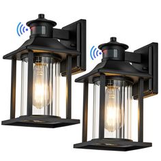 two black outdoor lights with one light on each side and the other off to the side