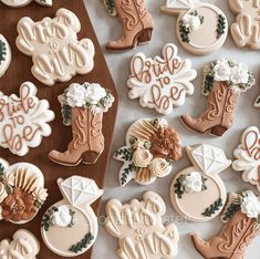 cookies decorated with cowboy boots and flowers on a table