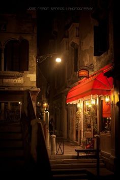 an empty street at night with red awnings