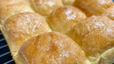 bread rolls sitting on top of a cooling rack