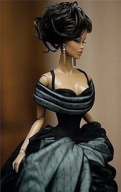 a barbie doll wearing a black dress and earrings