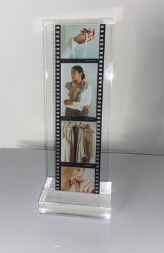 a film strip with pictures of men in clothes on it, and an image of a hand holding a tie